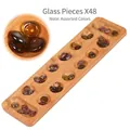 Close-up of natural wood Mancala board with 48 translucent brown glass stone pieces - Bamboo Mancala (Glass Beads)