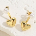 Macro detail of 14K gold heart earrings with white pearls on a textured stone surface - Heart Mirror Polish Pearl Earrings