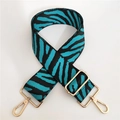 Close-up of zebra pattern wide strap in teal and black with gold adjustable buckles - Aqua