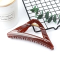 Elegant triangular dark brown resin hair claw clip with golden spring on white background - Glossy Reddish Brown