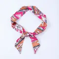 Pink and orange geometric print narrow silk scarf tied as an elegant hair accessory - X24-Multi