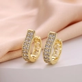 Macro shot of gold U-shaped hoop earrings with micro-paved zircons and hollow patterns - U-shape Double Row Pave