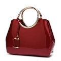 Chic dark red patent leather shoulder bag with golden round handle and glossy finish - Burgundy