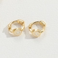 Macro view of gold hoop earrings featuring white smiley face charms on white background - White Smiley Face / Gold