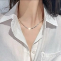 Elegant silver flat snake chain necklace worn by a model over a white shirt - Snake Chain (3mm) / Silver