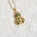 Golden necklace with crown bear pendant featuring sparkling green zircon gemstones - Green Zirconia