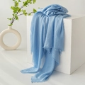 Light blue cotton linen scarf with fringe edges draped over a white minimalist prop - Sky Blue