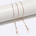 Macro shot of gold metal braided eyewear chain with white silicone anti-slip loops - Hollow Chain Rose Gold