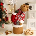 Plush Christmas reindeer figurine wearing a red sweater and carrying a small gift stocking - Twisting Reindeer Candy Bag Ornament