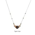Detailed view of tiger's eye stone pendant with golden metal beads on a sleek chain - Tiger's Eye-Gold Chain