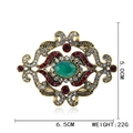 Vintage gold brooch with green gemstone, red rhinestones and 6.5cm floral pattern - Baroque Green Stone Brooch
