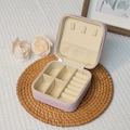 Portable pink jewelry storage box with rings slots and hooks on a decorative mat - Single Layer-Light Pink