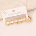 Detailed view of three pairs of golden stainless steel hoop earrings on a display card - 6# Flat Round