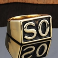 Macro detail of gold plated square punk ring with SO letter on dark wood background - Gold SO