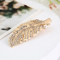 Detailed view of a gold feather hair clip featuring sparkling rhinestones and a pearl accent - Gold Feather Pearl (S223-5)