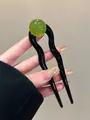 U-shaped hair fork in wavy black resin with a translucent green bead detail - Bright Black and Fruit Green