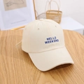 Beige baseball cap with Hello Weekend embroidery on a rustic wooden table surface - Beige