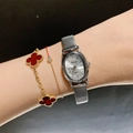 Elegant silver oval quartz watch with metal stretch band on wrist with gold jewelry - Metal Elastic Strap / Silver/White Dial