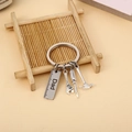 Detailed shot of stainless steel Dad keychain with miniature hammer and wrench tools - Dad Silver