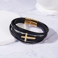 Detailed macro view of triple-layer braided black leather bracelet with golden cross charm - Gold/Multi-layer Cross