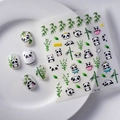 5D embossed panda and bamboo nail stickers on white tips displayed on a ceramic plate - Panda Crown Heart Style (FEB-132)
