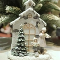 Miniature resin Christmas village scene with a snow-covered house and figures - Christmas Tree House (Light Up)