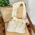 Detail of floral embroidery on cream chiffon shoulder bag with pearl strap charm - Beige