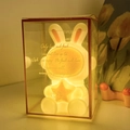 White rabbit astronaut night light in a gold-trimmed transparent gift box with warm glow - Space Bunny # Gold Star / Gift Box Version