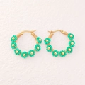 Detail of bohemian gold hoop earrings with handmade teal beaded flower charms - Green