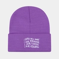 Detailed close-up of purple ribbed knit beanie featuring white embroidered slogans - Purple