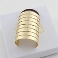 Golden striped metal ponytail cuff hair ring with brown elastic band on white box - Gold Large