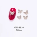 Macro detail of 7x6mm mini hollow butterfly nail charms with gold base and rhinestones - Gold Butterfly With Rhinestone (8820)