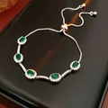 Detail of adjustable silver bracelet with five emerald-green oval stones and halo diamonds - Silver-Green