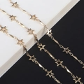 Detailed close-up of golden star-shaped metal chain links on a minimalist background - Star Twist Bar