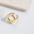 Detailed close-up of a gold-plated cross design open ring on a textured stone surface - Circle / Gold