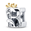 Macro shot of silver letter B charm with gold crown and sparkling crystal inlays - Letter E