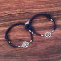 Detail of blue tree of life magnetic couple bracelets on a wooden background - Dark Blue Pair