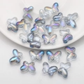 Macro detail of 10x14mm aurora butterfly glass beads with smooth finish for DIY jewelry - Semi-transparent Blue