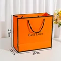 Large orange gift bag with black Best Love lettering and sturdy rope handles - Large / Orange