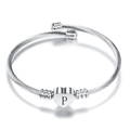 Detail shot of silver heart charm bracelet with engraved letter P on cable band - Letter P / Steel