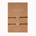 Handmade woven sun and moon sister bracelets set on a brown kraft display card - Sisters Silver