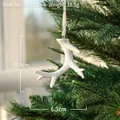 White coral-shaped resin reindeer antler ornament hanging on a green Christmas tree branch - Small White