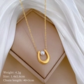 Detailed shot of a gold U-shaped pendant with white pearl in a beige jewelry box - Titanium Steel / Gold