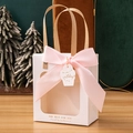 White gift bag with clear window, pink ribbon bow and Happy Birthday tag on a festive background - Beige + Birthday Tag