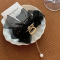 Elegant gold hair claw with black organza bow and hanging pearl tassel detail - Mesh Bow with Pearl Pendant / Black Lace