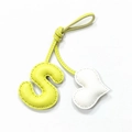 Detail of hand-stitched leather bag charm with yellow S letter and white heart pendant - Light Yellow with Off-white Heart