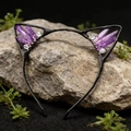 Detailed shot of purple crystal cat ear headband on a natural rock with greenery - Light Purple Cat Ears