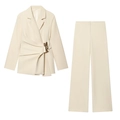 Detailed view of the irregular pleats and gold buckle on the cream blazer set - Off-white Set