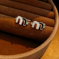 Macro shot of silver letter M earrings with zircon stones and black enamel inlay - Silver Black Letter M Style (Pair)
