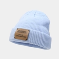 Detail of light blue ribbed beanie featuring a rectangular brown leather decorative patch - Light Blue
